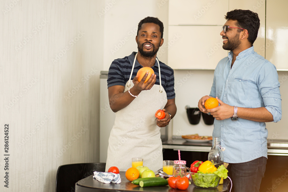 Handsome men standing in kitchen Handsome men standing in kitchen