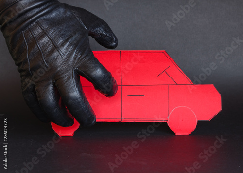 concept of theft of a car /A thief's hand approaches a car to steal it photo