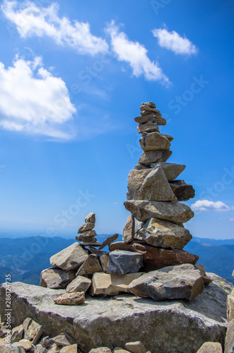 Balanced stacked stones with background scene of The Grand Ballon, Vosges, France.