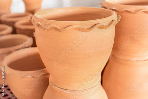 Empty ceramic brown flower pots for sale in Garden shop, Lots of orange brown terracota flower pots. photo