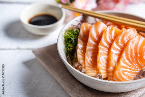 Salmon sashimi with soy sauce, raw fish in traditional Japanese style