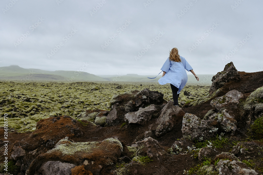 Young beautiful woman in an old moss-covered lava field  volcanic area in Iceland. Amazing nature