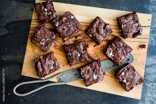 Overhead view of chocolate brownies on cutting board photo