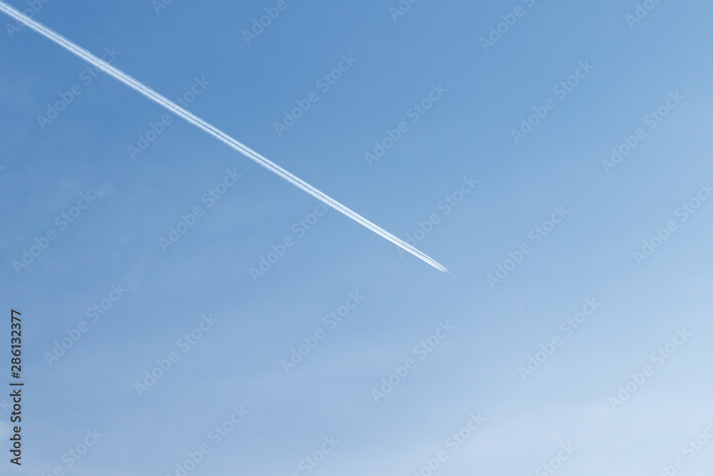 White plane flying high in blue sky White plane flying high in blue sky