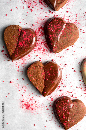 Close up of heart shaped chocolate dipped valentines cookies