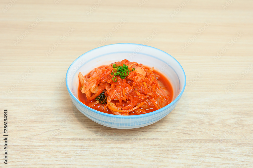 Napa cabbage kimchi in white bowl of side dishes Napa cabbage kimchi in white bowl of side dishes