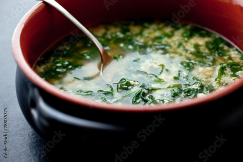 Close up of stracciatella with spinach in turkey broth