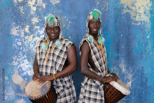Two African musician with traditional clothes and drums photo