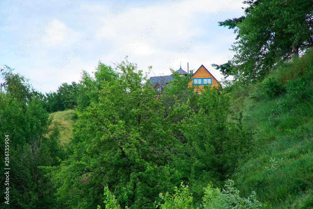 Wooden cottage in the valley, cozy house, cloudy weather