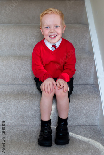 school boy sat on stepps