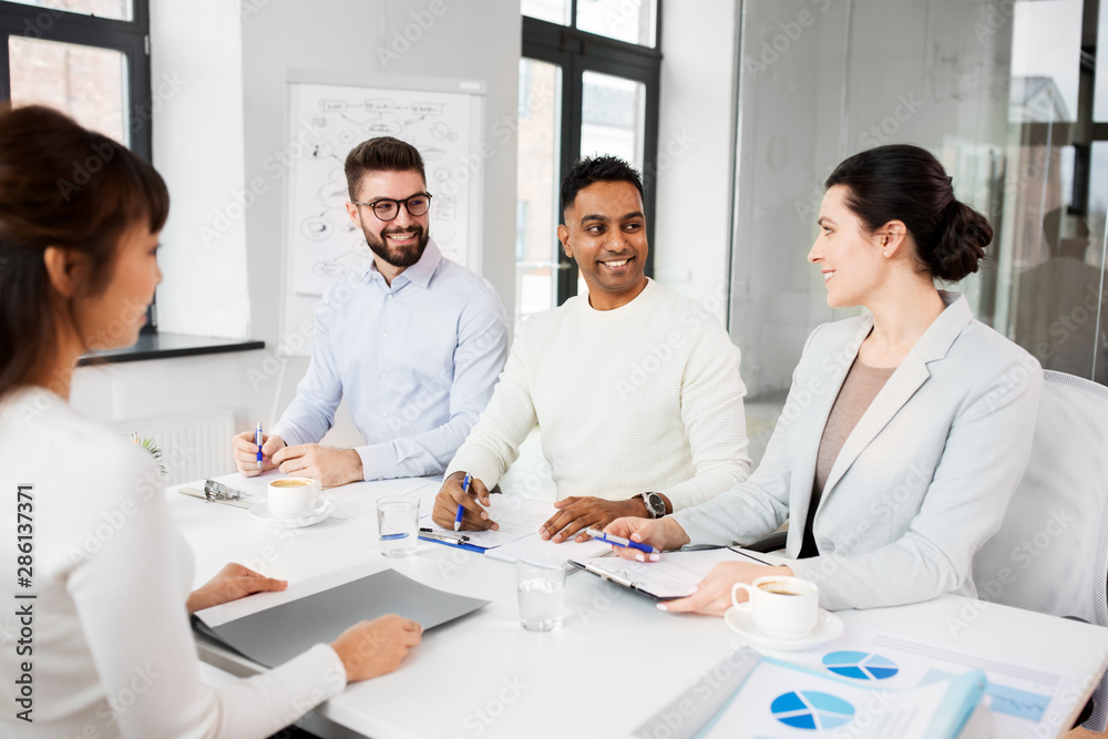 new job, hiring and employment concept - international team of recruiters having interview with female employee at office new job, hiring and employment concept - international team of recruiters having interview with female employee at office