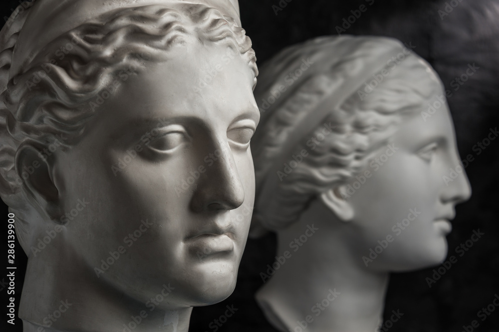 Gypsum copy of ancient statue Venus and Diana head on dark textured background. Plaster sculpture face. Gypsum copy of ancient statue Venus and Diana head on dark textured background. Plaster sculpture face.