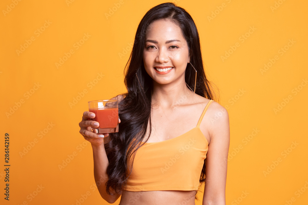 Young Asian woman drink tomato juice. Young Asian woman drink tomato juice.