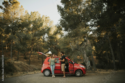 Couple on a road trip, taking a break