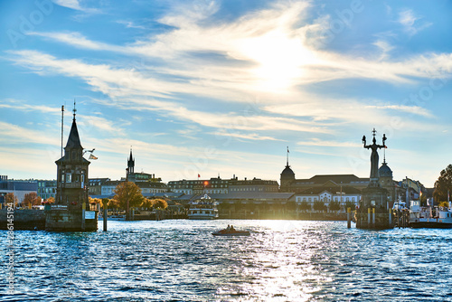 Germany, Baden-Wuerttemberg, Constance district, Constance, Harbor entrance, Imperia statue and pegel tower against the sun photo