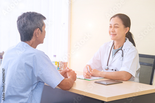 Healthcare and medical concept. Asian professional woman doctor with medical equipment measuring elder patient's blood pressure and pulse.