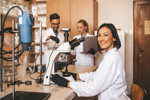 Middle age scientists and researchers work in chemical laboratory.