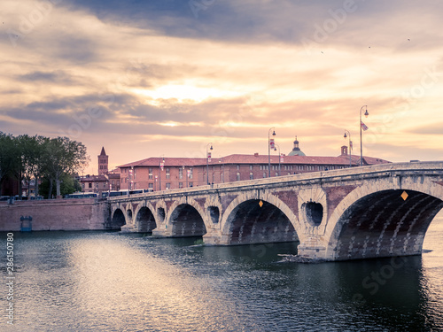 Atardecer en la ciudad de Toulousse, Francia, con el puente sobre el rio Garona y las tipicas casa de ladrillo rojo.