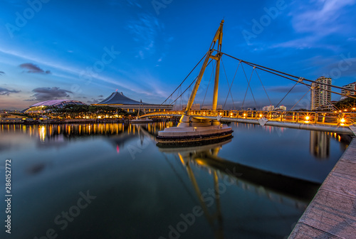 Tanjong Rhu Suspension Bridge reflecting in Geylang River at dusk photo