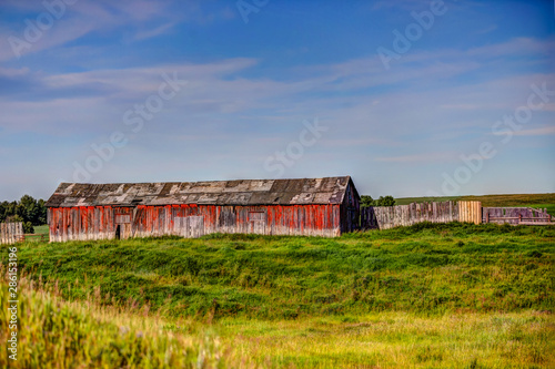 Farm structures among wheat fields in the Alberta countryside © Torval Mork