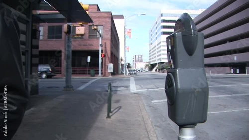 Wallpaper Mural woman putting money in a parking meter. Torontodigital.ca