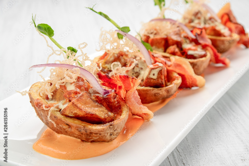 Potato skin with bacon and cheese, tomato sauce Potato skin with bacon and cheese, tomato sauce