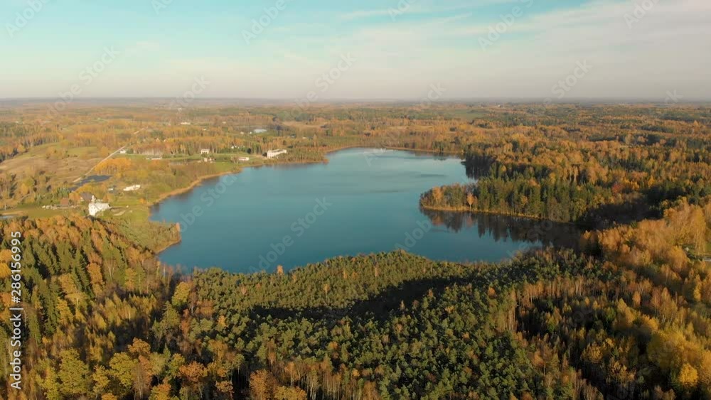 Bird's-eye view of autumn forest and a small lake Bird's-eye view of autumn forest and a small lake
