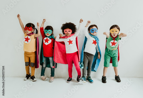 Fototapeta Group of Diverse Children Playing superhero on the white wall background