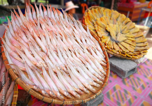 Fresh fishs placed on a bamboo basket drying with sunlight, Fish being traditionally dried using sun heat and wind, The sun dried fish is a method of preservation food-Image