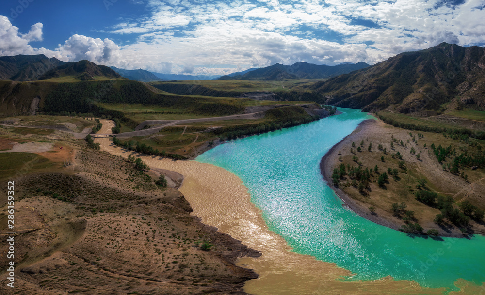 The confluence of two rivers, Katun and Chuya, the famous tourist spot in the Altai mountains, Siberia, Russia, aerial shot.