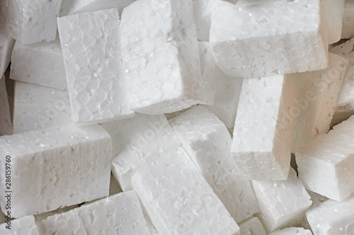 Heap of many rectangular pieces of styrofoam for packing parcels. Close-up. Background photo