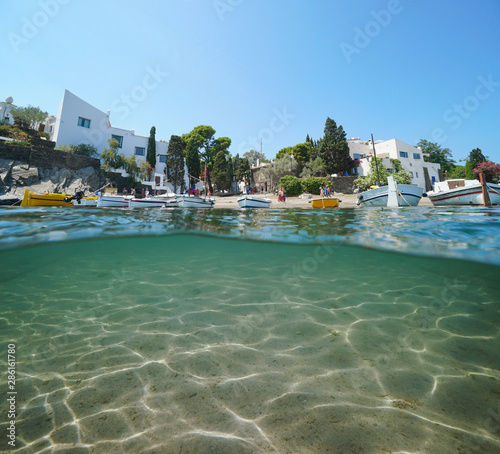 Spain Portlligat village coastline with boats and sand underwater, Mediterranean sea, split view above and below water surface, Cadaques, Costa Brava, Catalonia