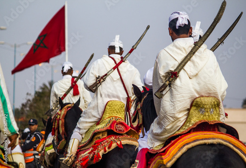 Festival Tbourida traditional culture Morocco Knights on horses with fire arms photo