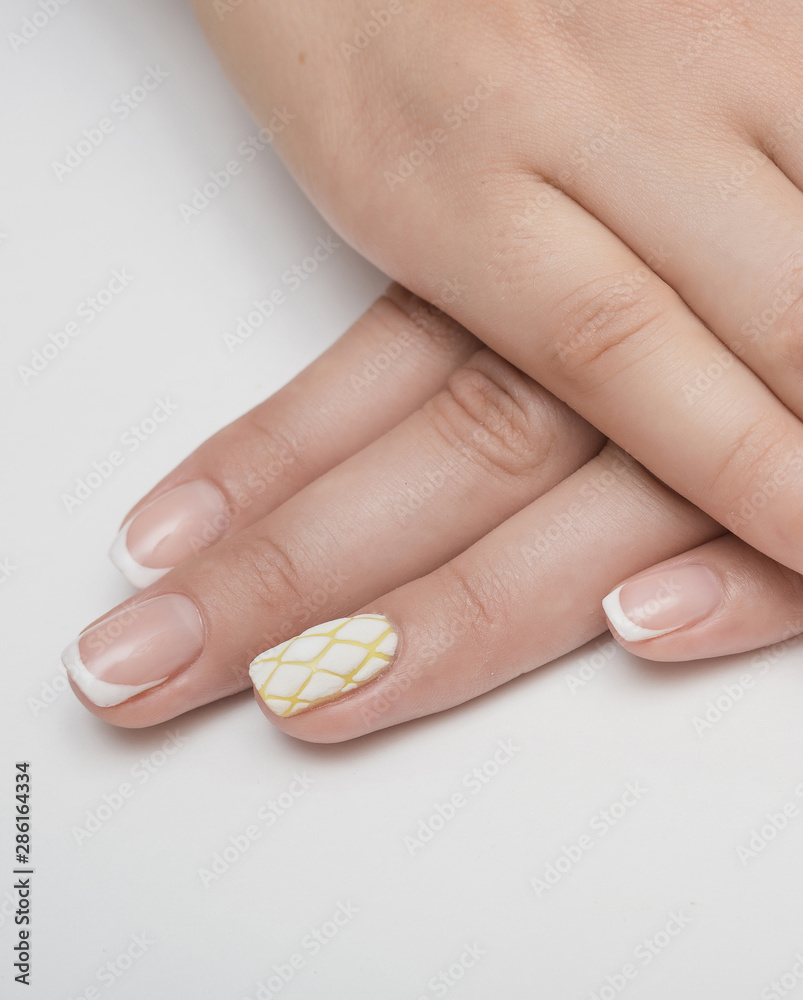 Female hands with bright yellow manicure hold yellow carnations Female hands with bright yellow manicure hold yellow carnations
