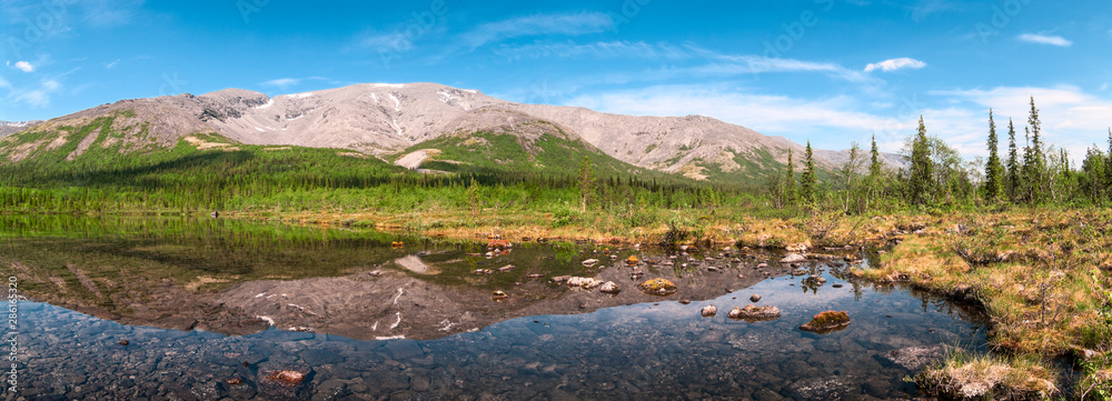 Panorama of mountain valley with calm clear water of the lake. Khibiny Mountains is on Kolsky Peninsula, northern Russia