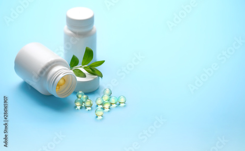 Assorted pharmaceutical medicine tablet, capsules and fresh green plant. medicine pill, vitamin supplement, Medical drug. concept organic preparations. close up. shallow depth, soft focus