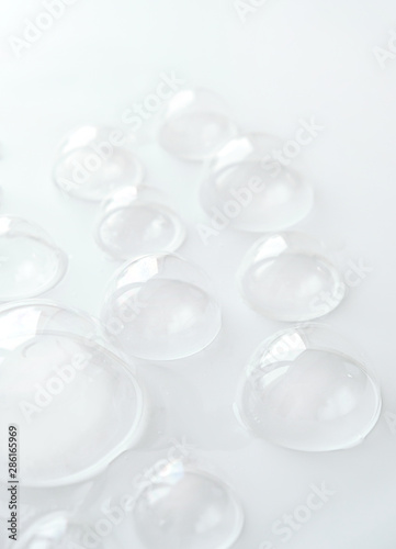 soap bubble on white background. white foam bubbles abstract backdrop. conceptual template with clear soap bubbles. concept of pure, cleanliness and cleaning products. soft selective focus