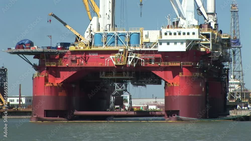 A large oil or gas drlling platform with seagulls flying around. A large oil or gas drlling platform with seagulls flying around.