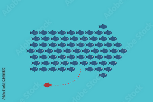 Think differently -One red unique different fish swimming opposite way of identical blue ones.  