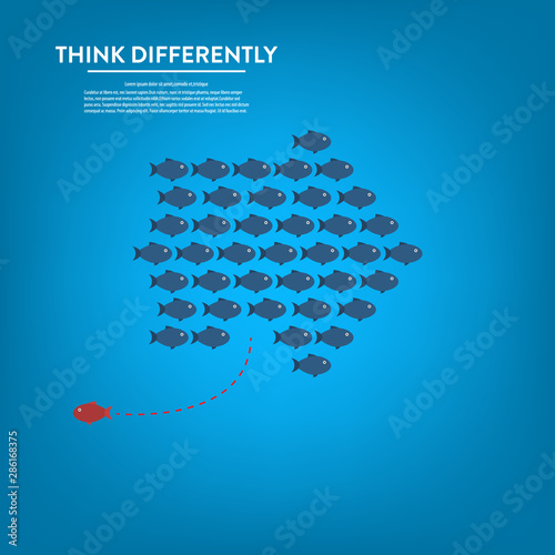 Think differently -One red unique different fish swimming opposite way of identical blue ones.  