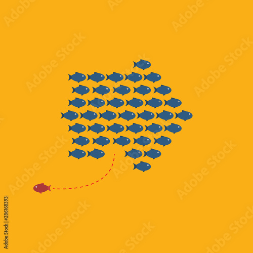 Think differently -One red unique different fish swimming opposite way of identical blue ones.  