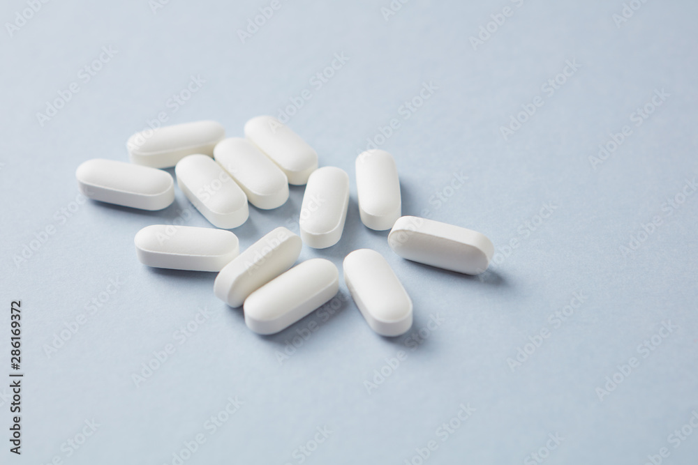 Lysine tablets. Concept for a healthy dietary supplementation. Nervous System Support. Bright background. Close up. Copy space. Lysine tablets. Concept for a healthy dietary supplementation. Nervous System Support. Bright background. Close up. Copy space.