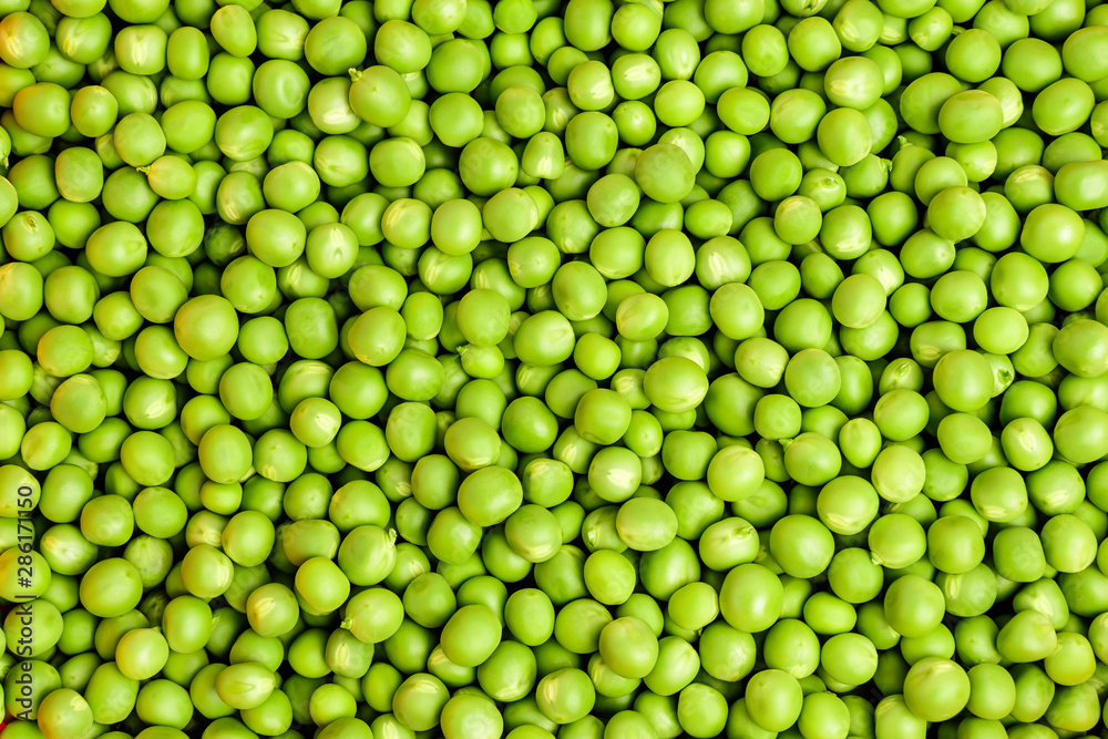 Natural background of many fresh organic green peas, top view Natural background of many fresh organic green peas, top view