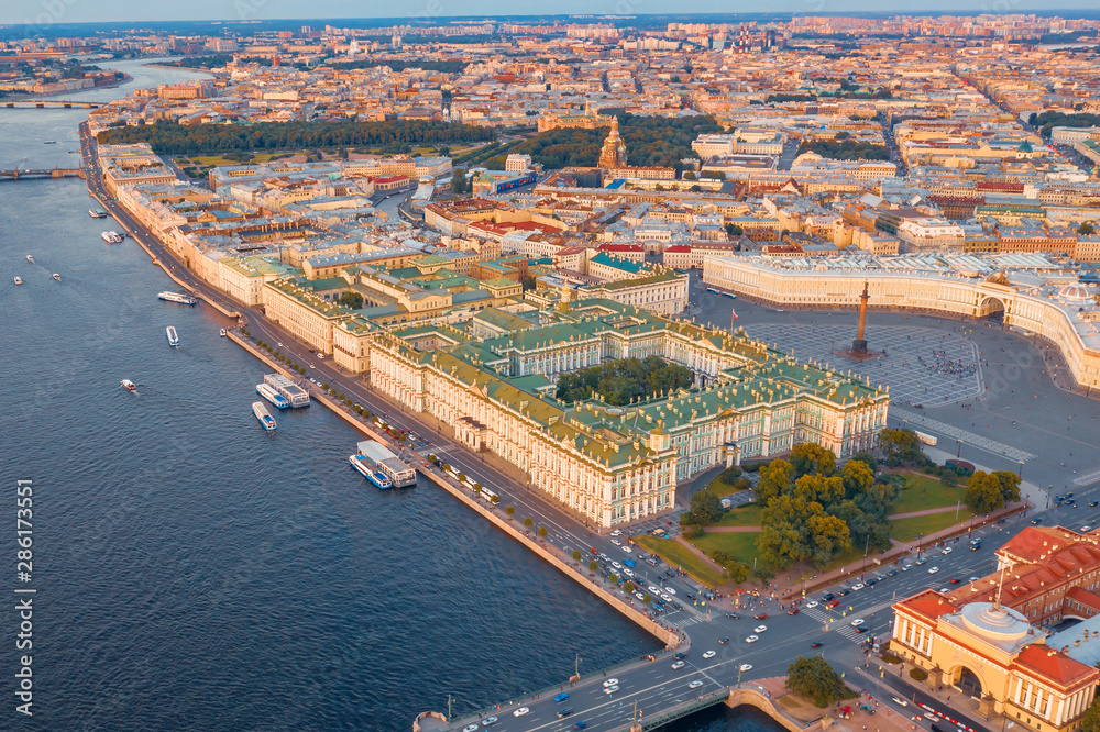 Aerial view of Palace Square Hermitage Winter Palace and embankment of the Neva River in the evening at sunset.