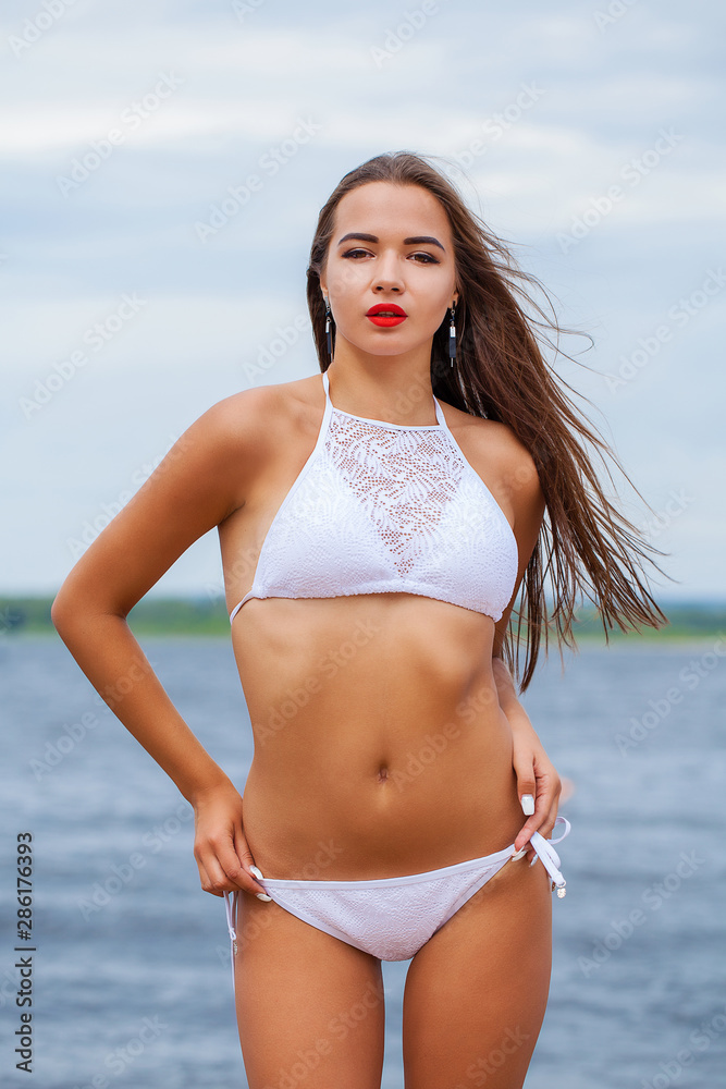 Close up portrait beautiful sexy brunette woman in white bikini Close up portrait beautiful sexy brunette woman in white bikini