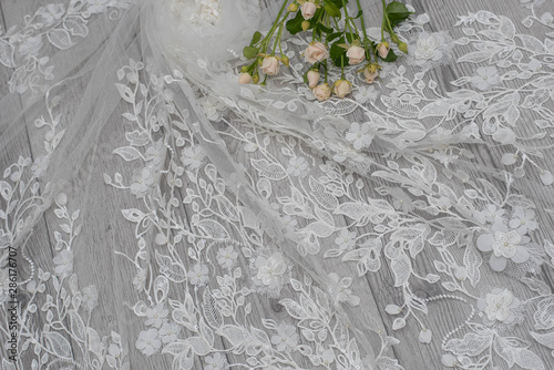 The texture of lace on wooden background decoreted roses. photo