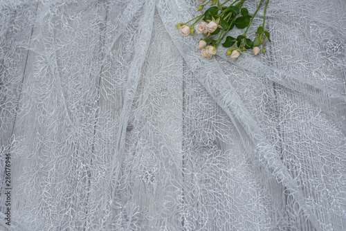 The texture of lace on wooden background decoreted roses. photo