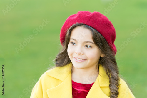 So beautiful. autumn fashion style. fall season. happy childhood. small child with curly hair. parisian girl kid in french beret. beauty and fashion. autumn coat. cheerful little girl in yellow coat