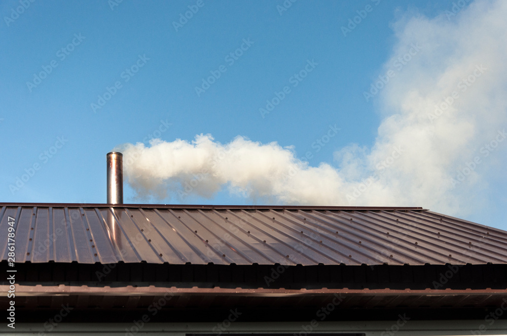 Smoke coming out the chimney against sky Smoke coming out the chimney against sky