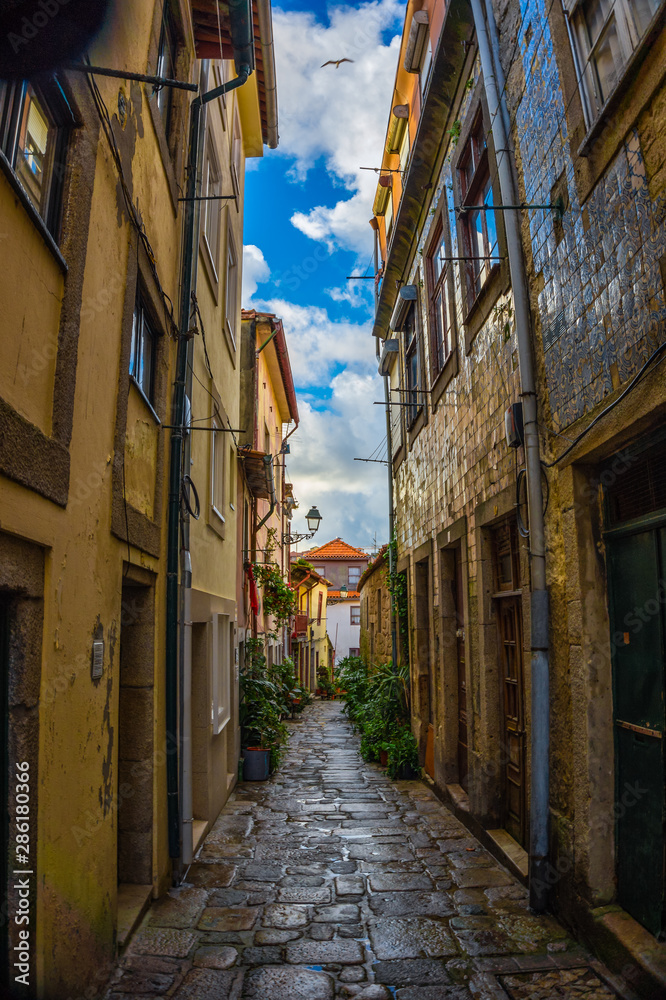 Narrow street in old town with small houses in centre, Porto